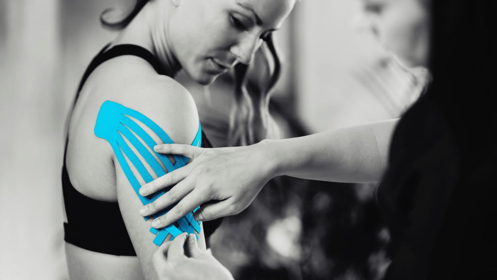 physical therapist applying kinesiology tape in a professional physical therapy clinic