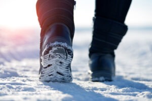 Female feet in winter boots, in the snow, exercising in cold weather and snow